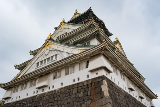 Osaka castle in cloudy sky before the rain fall down in Osaka, Japan.