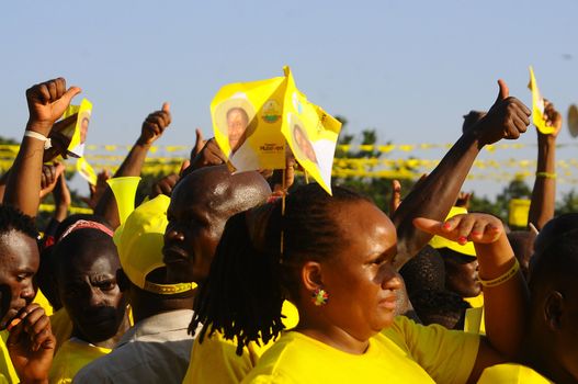 UGANDA, Kampala : Supporters of Uganda's incumbent leader and presidential candidate Yoweri Museveni cheer him during his last electoral rally at Kololo Airstrip in Kampala on February 16, 2016.Uganda's presidential contenders held their final campaign rallies on February 16, a day after opposition supporters clashed with police leaving at least one person dead. Museveni and his ruling National Resistance Movement (NRM) party is widely predicted to win a fifth term in power in polls, and warned at a rally against voting for his rivals. 