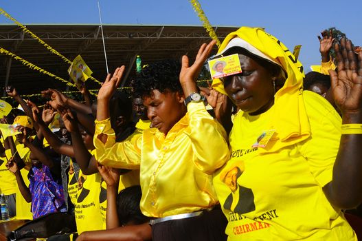 UGANDA, Kampala : Supporters of Uganda's incumbent leader and presidential candidate Yoweri Museveni pray during his last electoral rally at Kololo Airstrip in Kampala on February 16, 2016.Uganda's presidential contenders held their final campaign rallies on February 16, a day after opposition supporters clashed with police leaving at least one person dead. Museveni and his ruling National Resistance Movement (NRM) party is widely predicted to win a fifth term in power in polls, and warned at a rally against voting for his rivals. 