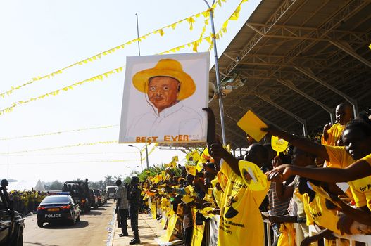 UGANDA, Kampala : Supporters of Uganda's incumbent leader and presidential candidate Yoweri Museveni cheer him during his last electoral rally at Kololo Airstrip in Kampala on February 16, 2016.Uganda's presidential contenders held their final campaign rallies on February 16, a day after opposition supporters clashed with police leaving at least one person dead. Museveni and his ruling National Resistance Movement (NRM) party is widely predicted to win a fifth term in power in polls, and warned at a rally against voting for his rivals. 