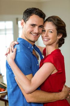 Portrait of romantic couple embracing each other in kitchen