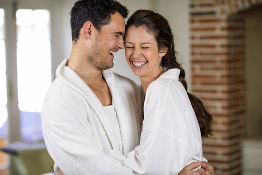 Romantic young couple embracing each other in kitchen