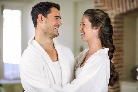 Romantic young couple embracing each other in kitchen