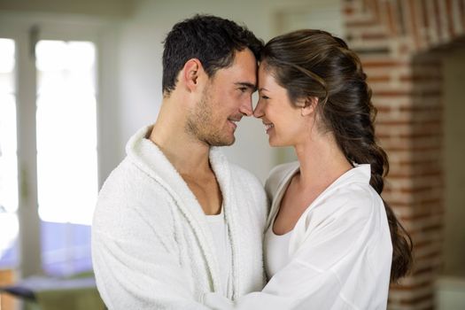 Romantic young couple embracing each other in kitchen