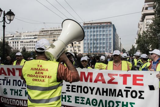GREECE, Athens : A man uses a speaker as Greek port and dock workers protest in central Athens against the selling of country's ports on February 17, 2016.Greek dock workers are on a second day of 48-hours strike to protest against the sale of the country's two biggest ports, which Athens has promised to international lenders, disrupting operations at cargo terminals.