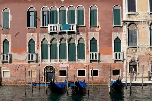 Gondolas floating on Canal with traditional building in the background, Venice, Italy