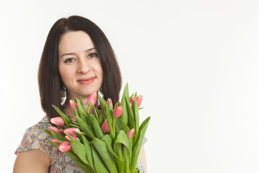 the beautiful woman holds a bouquet of tulips