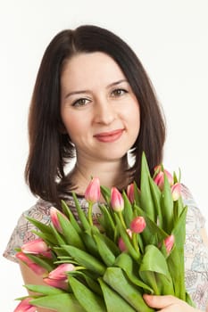 the beautiful woman holds a bouquet of tulips