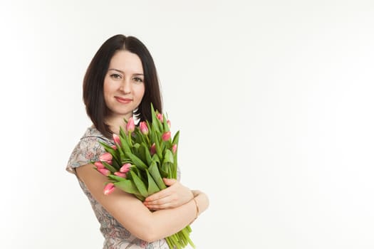 the beautiful woman holds a bouquet of tulips