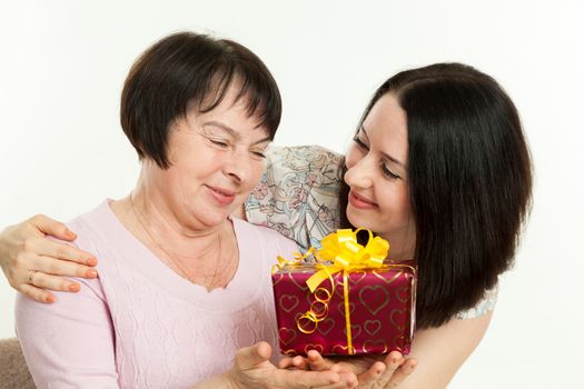 the woman gives to mother a gift