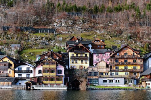 Houses of Hallstatt old town village on river bank between lake and mountain