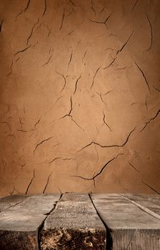 Brown clay wall and old wooden table