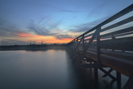 Wooden Boardwalk at sunset, to journey through Bolsa Chica Wetlands preserve in Huntington Beach, California, United States