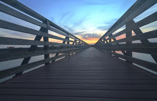 Wooden Boardwalk at sunset, to journey through Bolsa Chica Wetlands preserve in Huntington Beach, California, United States