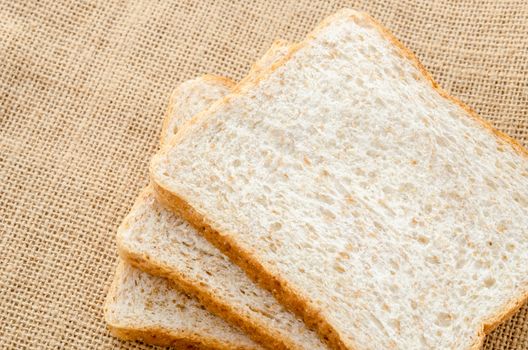 Fresh bread wheat slices on white background