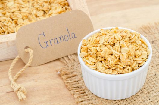 oatmeal granola in white cup with granola tag paper.