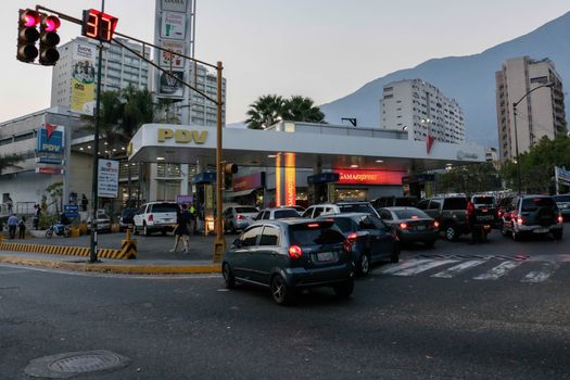 VENEZUELA, Caracas: Cars queue at a gas station in Caracas, on February 17, 2016. Venezuela's President Nicolas Maduro said Wednesday he would raise the price of gasoline for the first time in 20 years, as he faces growing pressure to ease an economic crisis. Maduro said in a televised address he would raise the pump price of premium gasoline from its current super-low level of $0.01 to the equivalent of $0.95 at the fixed official exchange rate, in a country where citizens are struggling with soaring inflation.