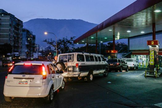 VENEZUELA, Caracas: Cars queue at a gas station in Caracas, on February 17, 2016. Venezuela's President Nicolas Maduro said Wednesday he would raise the price of gasoline for the first time in 20 years, as he faces growing pressure to ease an economic crisis. Maduro said in a televised address he would raise the pump price of premium gasoline from its current super-low level of $0.01 to the equivalent of $0.95 at the fixed official exchange rate, in a country where citizens are struggling with soaring inflation.