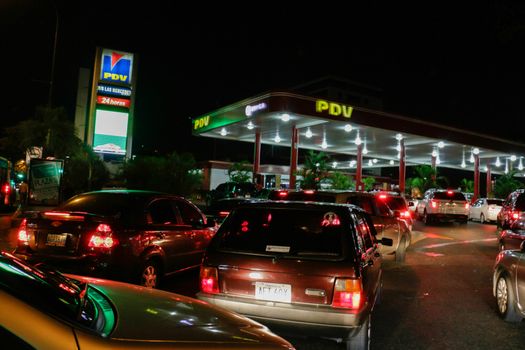 VENEZUELA, Caracas: Cars queue at a gas station in Caracas, on February 17, 2016. Venezuela's President Nicolas Maduro said Wednesday he would raise the price of gasoline for the first time in 20 years, as he faces growing pressure to ease an economic crisis. Maduro said in a televised address he would raise the pump price of premium gasoline from its current super-low level of $0.01 to the equivalent of $0.95 at the fixed official exchange rate, in a country where citizens are struggling with soaring inflation.