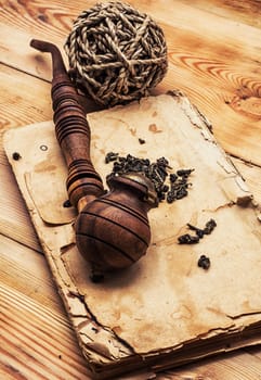 Smoking pipe in a retro style,dark chocolate  on wooden background