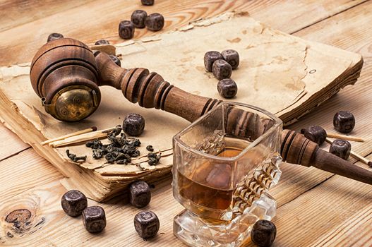 Smoking pipe in a retro style,dark chocolate and glasses of whiskey on wooden background