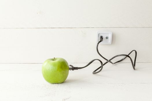 The picture shows an apple connected to an ethernet cable conceptualizing the internet of things and wearables