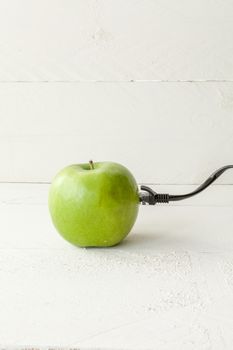 The picture shows an apple connected to an ethernet cable conceptualizing the internet of things and wearables