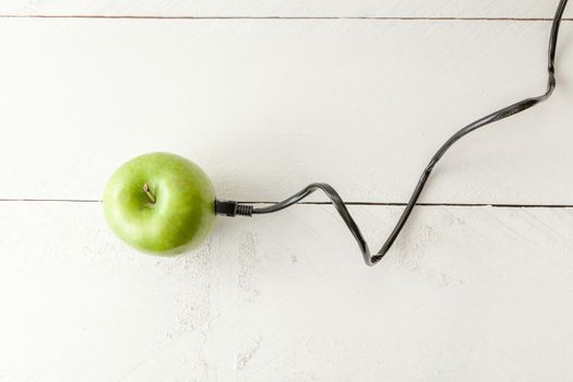 The picture shows an apple connected to an ethernet cable conceptualizing the internet of things and wearables