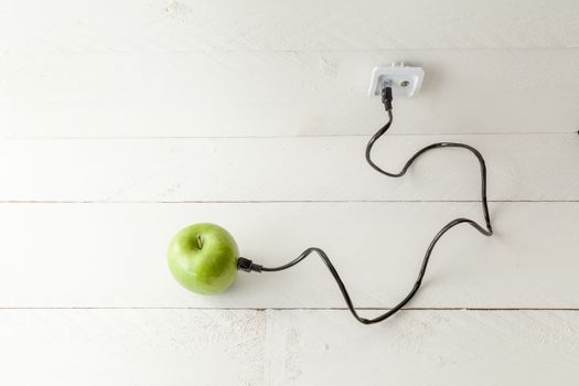 The picture shows an apple connected to an ethernet cable conceptualizing the internet of things and wearables