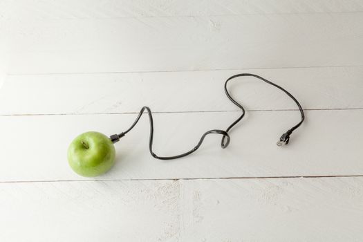 The picture shows an apple connected to an ethernet cable conceptualizing the internet of things and wearables