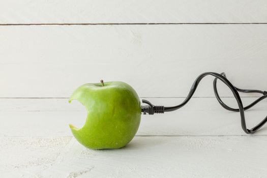 The picture shows an apple connected to an ethernet cable conceptualizing the internet of things and wearables