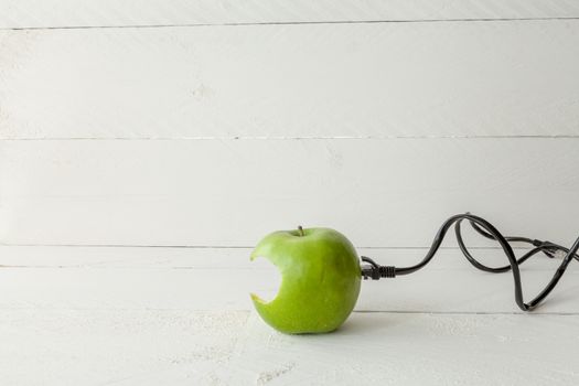 The picture shows an apple connected to an ethernet cable conceptualizing the internet of things and wearables