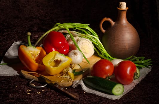 Fresh vegetables for cooking on a black background. Filmed from the light brush.