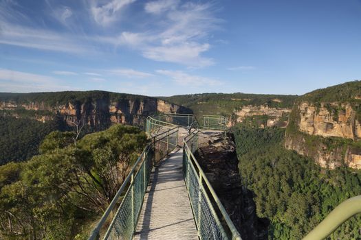 A small narrow bridge helps your traverse the narrow precipice with safety to one of the lookout posts.   A further steep ladder takes you down onto a lower smaller ledge and lookout.  Vigorous movement in the tree along the bridge shows just has gusty it was up there.
