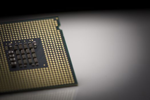 Macro shot of microprocessor with shallow depth of field on grey gradient