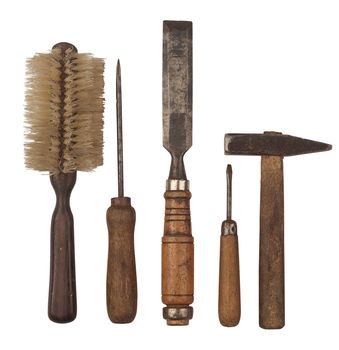 Horizontal side view of a set of heavily used working tools isolated on white background