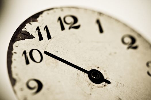 Horizontal close up of a clock dial showing ten o’clock