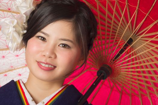 A portrait of a beautiful young Japanese girl in a blue kimono for her coming of age ceremony on her 20th birthday.