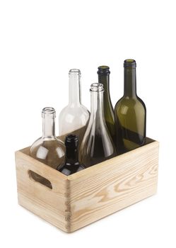 Wooden crate with wine bottles of different colors and sizes.