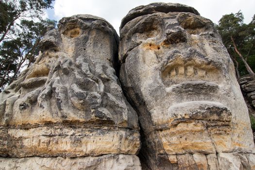 Heads of Devils are about 9 m high rock sculptures of giant heads carved into the sandstone cliffs in the pine forest above the village Zelizy in the district Melnik, Czech republic. It is the work of sculptor Vaclav Levy, who created in the period 1841-1846.