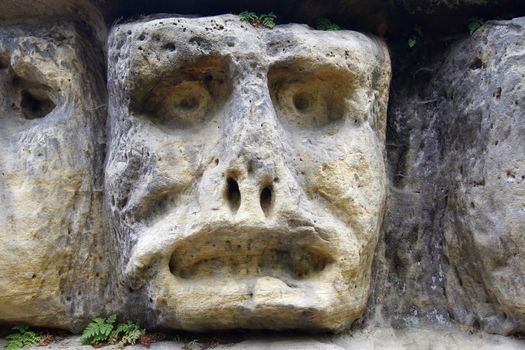 Harpist - rock sculptures of giant heads and other sculptures carved into the sandstone cliffs in the pine forest above the village Zelizy in the district Melnik, Czech republic. It is the works of sculptor Vaclav Levy, who created in the period 1841-1846.