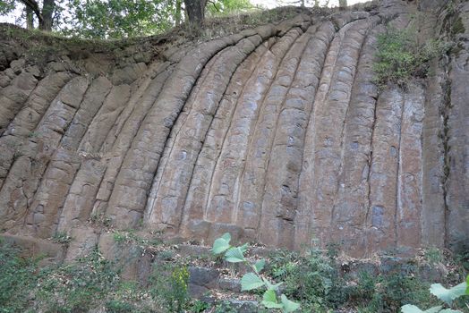 Konojedy Rock Loaves - former quarry at the foot of the northwestern slope of the mountain Dubi near the village Konojedy, Czech republic. Elongated, forested massif is a rest of several lava flows. Here you can see an example of basalt columnar jointing. Konojedy, Czech republic.