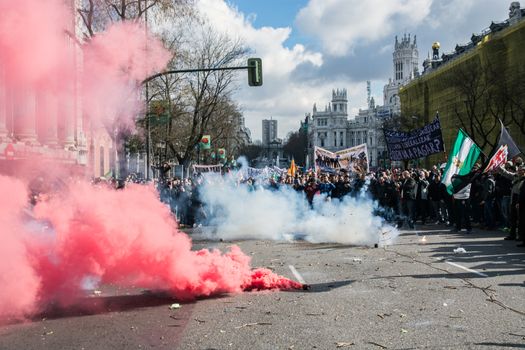SPAIN, Madrid: Smoke bombs are seen on the street as thousands of taxi drivers demonstrate against deregulation and ride-hailing companies such as Uber, in Madrid, on February 18, 2016.