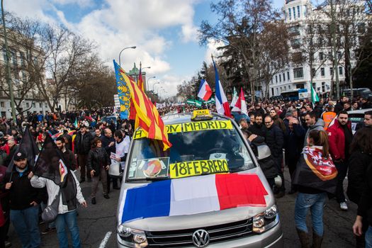 SPAIN, Madrid: French flags are seen on a cab as thousands of taxi drivers demonstrate against deregulation and ride-hailing companies such as Uber, in Madrid, on February 18, 2016.