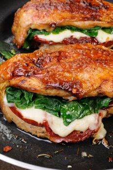 Baked chicken breast stuffed with mozzarella, spinach, sun-dried tomatoes