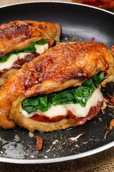 Baked chicken breast stuffed with mozzarella, spinach, sun-dried tomatoes