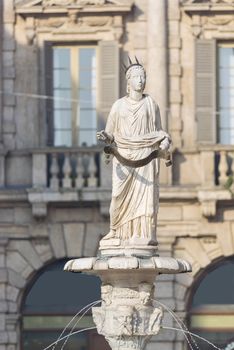 The ancient roman statue called Madonna Verona on a fountain in Piazza delle Erbe in Verona,