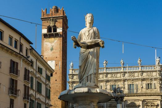 The ancient roman statue called Madonna Verona on a fountain in Piazza delle Erbe in Verona,