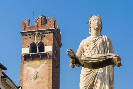 The ancient roman statue called Madonna Verona on a fountain in Piazza delle Erbe in Verona,