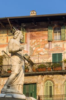 The ancient roman statue called Madonna Verona on a fountain in Piazza delle Erbe in Verona,